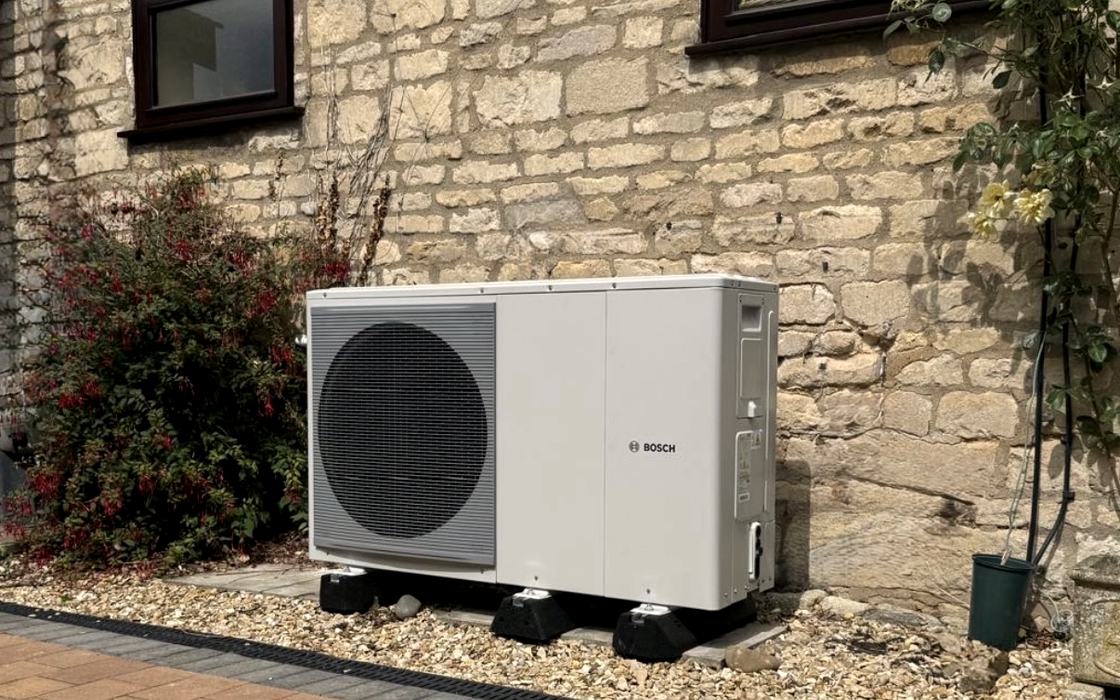 Bosch air source heat pump installed on a stone cottage